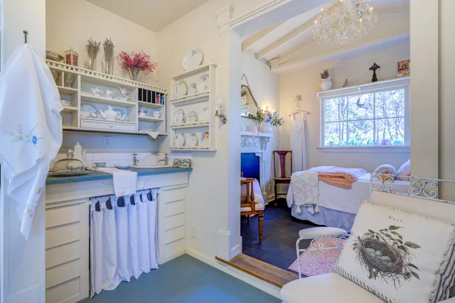 a pathway of a house with a yard and a fountain