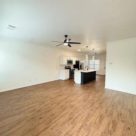 a view of a kitchen with a sink and a refrigerator