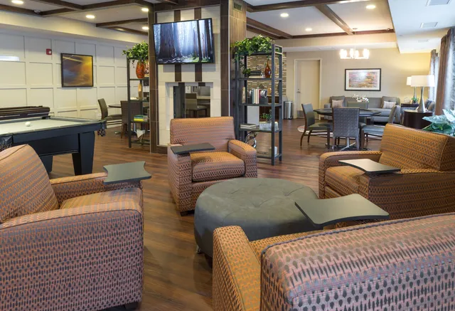 a living room with furniture kitchen and a table