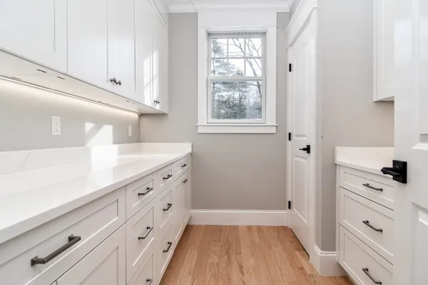 a kitchen with granite countertop white cabinets and white appliances