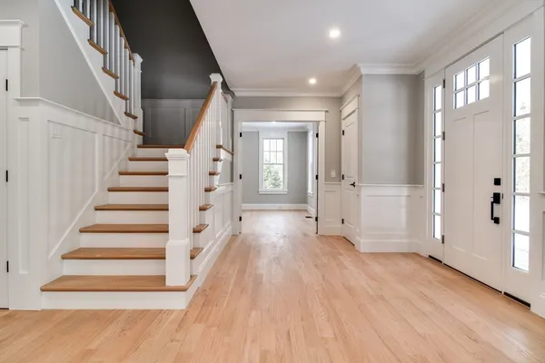 a view of an entryway with wooden floor and stairs
