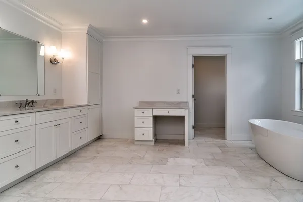 a spacious bathroom with a granite countertop sink and mirror
