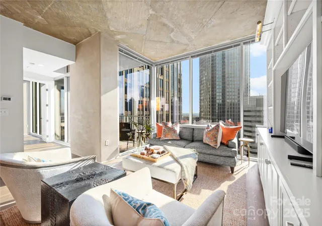 a living room with furniture and large windows