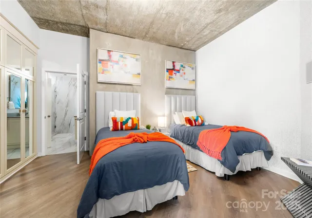 a bedroom with 2 bed and a window