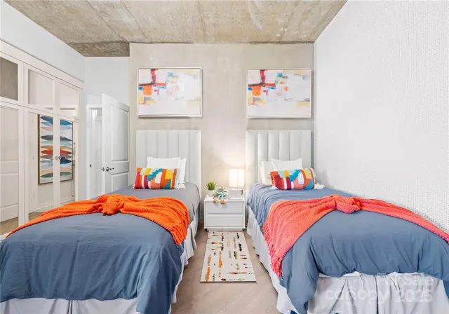 a bedroom with two beds and a window