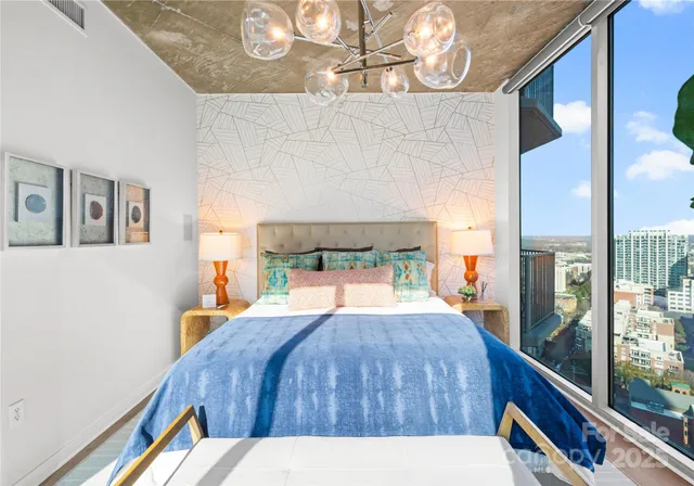 a bed sitting in a bedroom next to a window