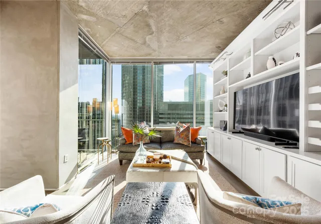 a living room filled with furniture and a flat screen tv