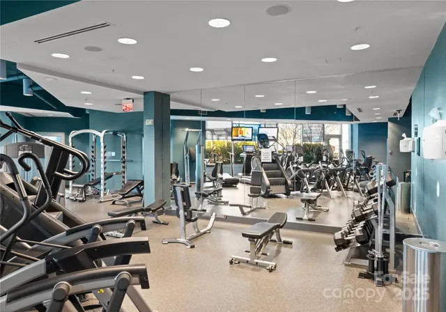 a room with gym equipment and lots of equipment