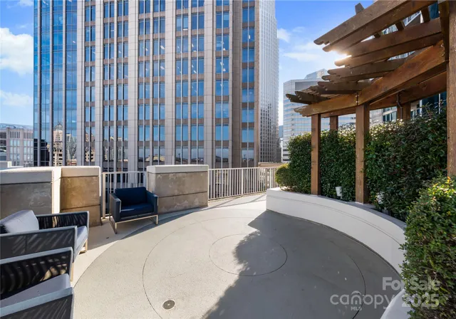 a view of backyard with outdoor seating and plants