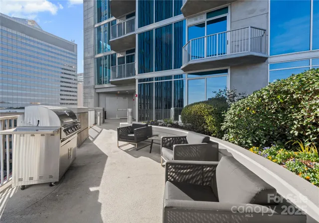 a view of a swimming pool with outdoor seating and plants