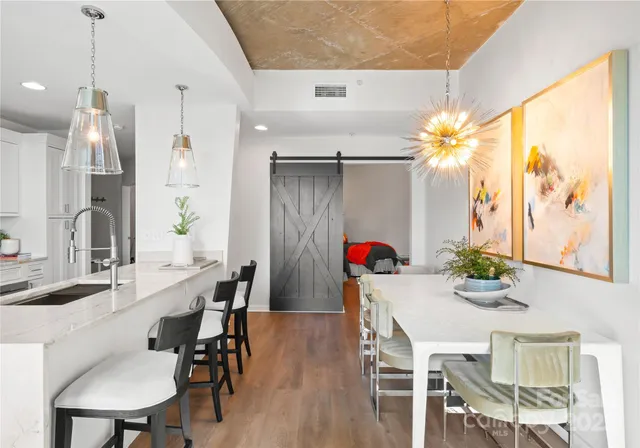a view of a dining room with furniture and wooden floor