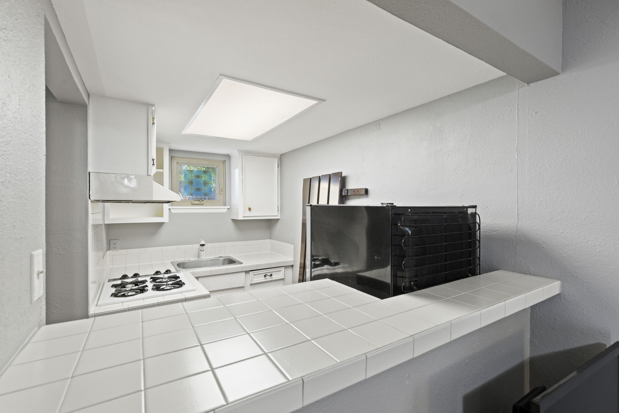 7808 Watson Street, Unit B Austin, TX 78757 - Photo 8 of 12 a kitchen with a stove a refrigerator and a cabinets