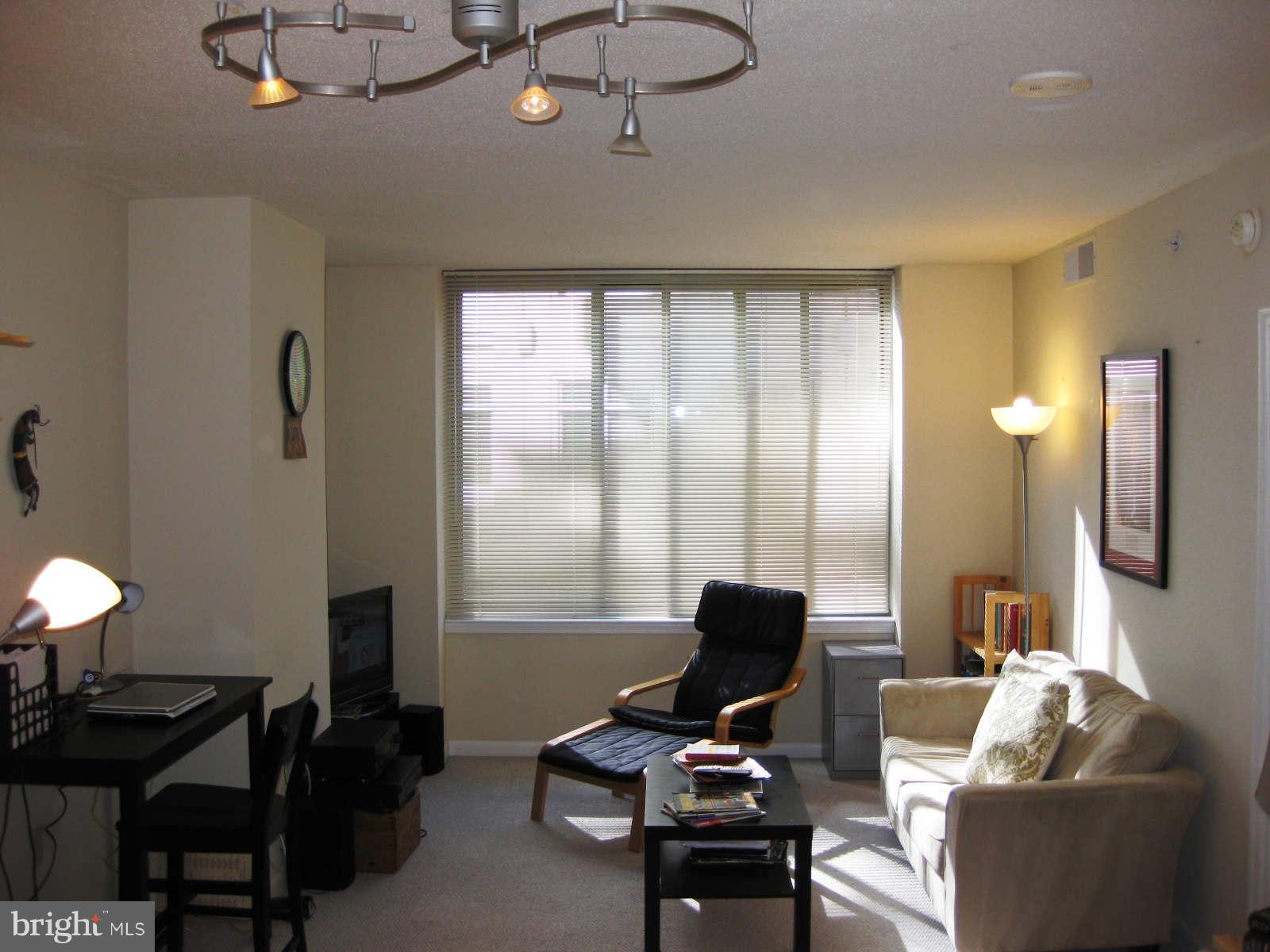 851 North Glebe Road, Unit 1018 Arlington, VA 22203 - Photo 3 of 24 a work room with furniture and a window