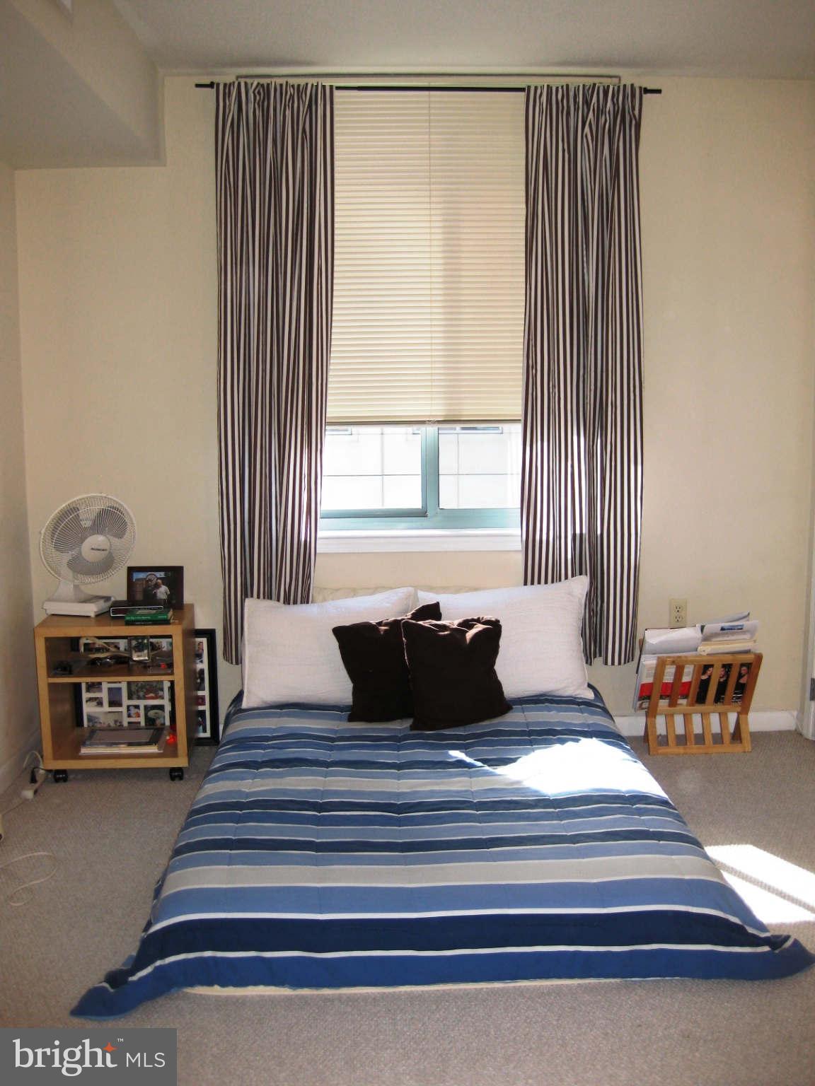 851 North Glebe Road, Unit 1018 Arlington, VA 22203 - Photo 6 of 24 a bedroom with a bed and window