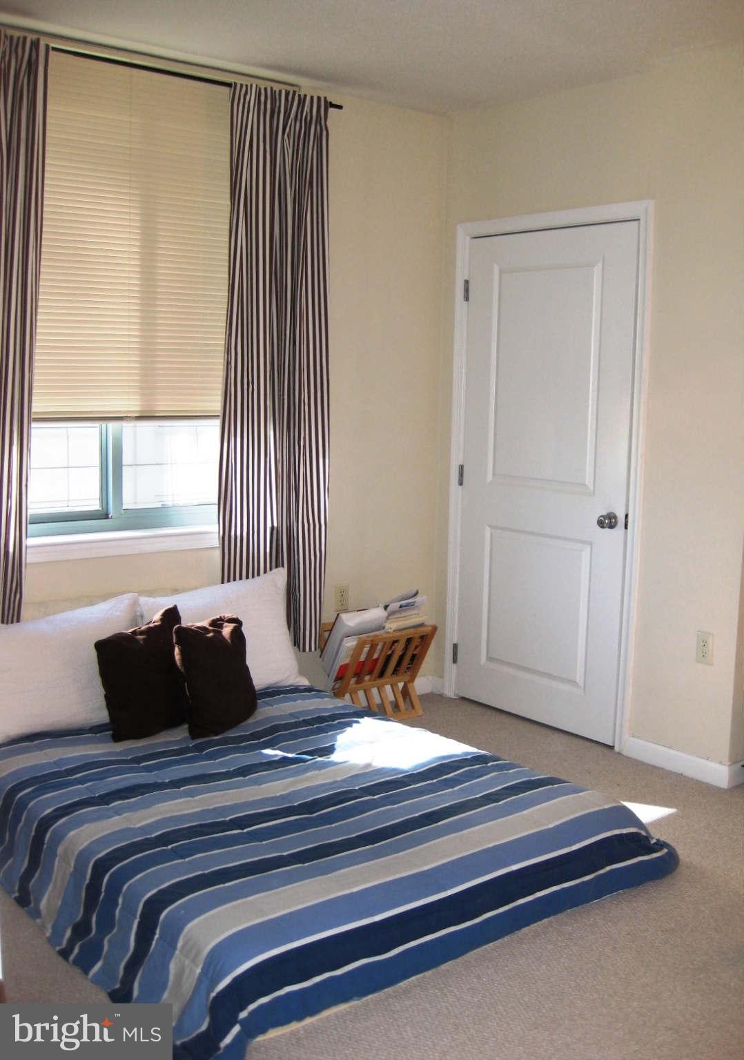 851 North Glebe Road, Unit 1018 Arlington, VA 22203 - Photo 9 of 24 a bedroom with a bed and a window