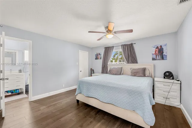 a bedroom with a bed and a ceiling fan