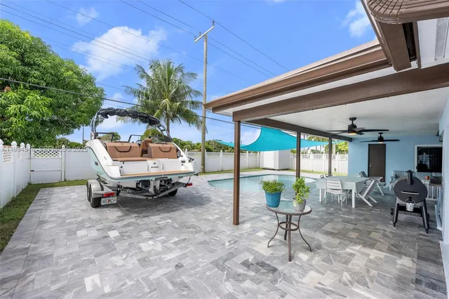 a living room with furniture and a ceiling fan