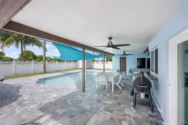 a front view of a house with a yard and potted plants