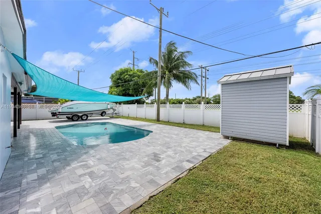 a view of a house with backyard porch and sitting area