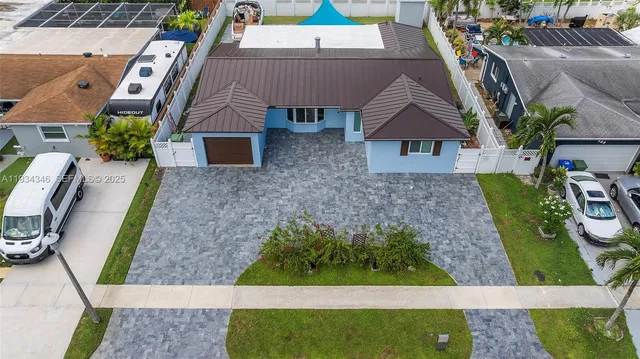 an aerial view of a house with a yard