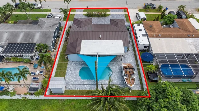 an aerial view of multiple houses with a yard