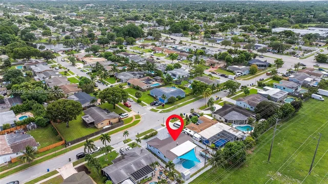 a view of a house with garden and a sitting area