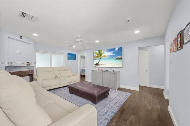 a living room with furniture and a wooden floor