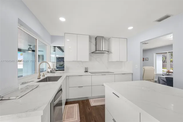 a view of kitchen with refrigerator stove and wooden floor