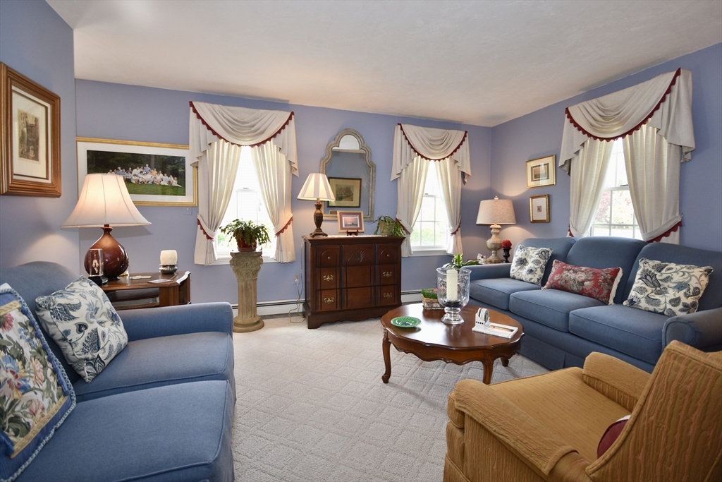 6 Oakbluff Road Bourne, MA 02562 - Photo 15 of 36 a living room with furniture fireplace and a large window