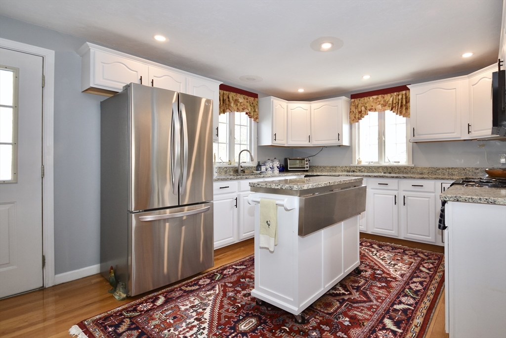 6 Oakbluff Road Bourne, MA 02562 - Photo 18 of 36 a kitchen with a refrigerator a sink and wooden floor