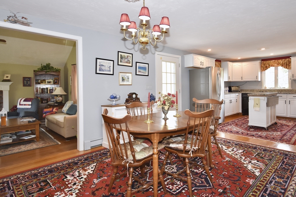 6 Oakbluff Road Bourne, MA 02562 - Photo 20 of 36 a view of a dining room with furniture and a chandelier