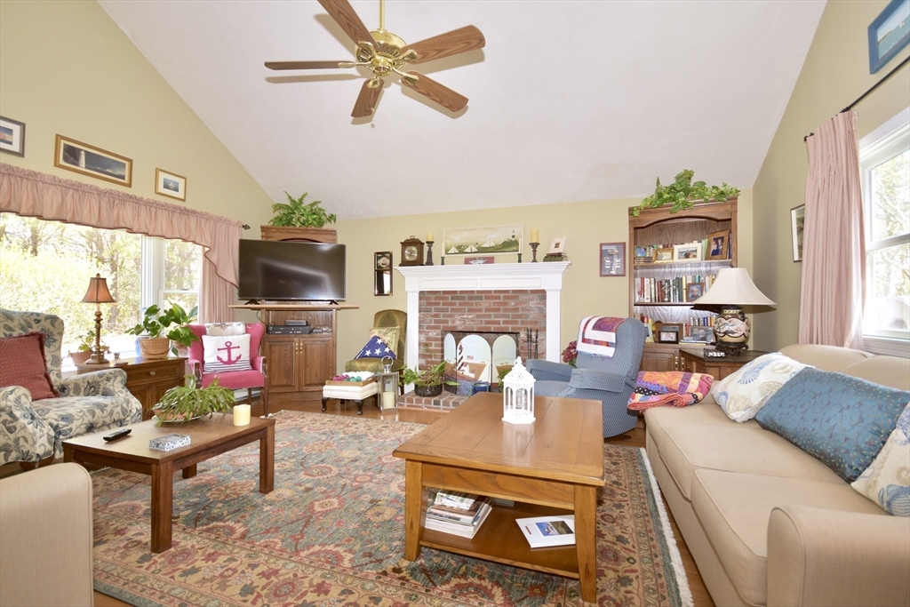 6 Oakbluff Road Bourne, MA 02562 - Photo 22 of 36 a living room with furniture a fireplace and a flat screen tv
