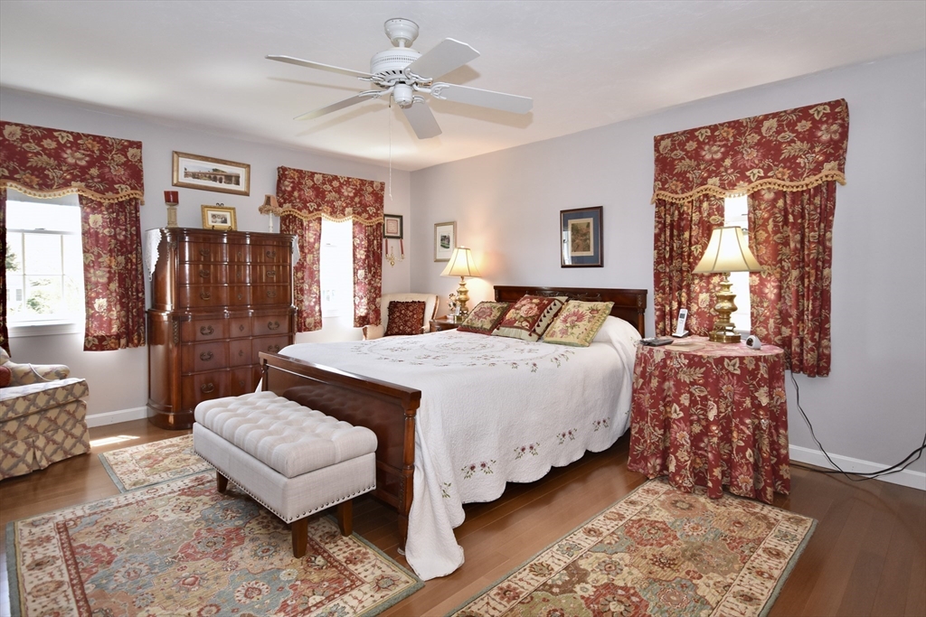 6 Oakbluff Road Bourne, MA 02562 - Photo 25 of 36 a bedroom with a bed and wooden floor