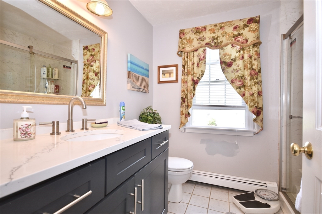 6 Oakbluff Road Bourne, MA 02562 - Photo 27 of 36 a bathroom with a granite countertop sink toilet a mirror and a window