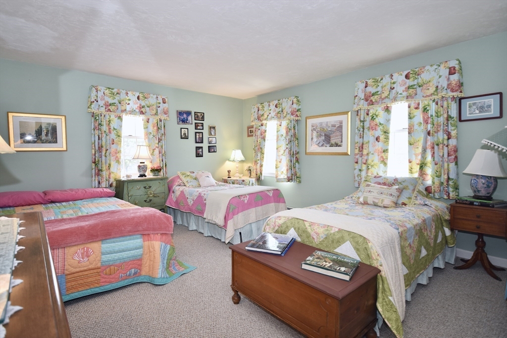 6 Oakbluff Road Bourne, MA 02562 - Photo 28 of 36 a bedroom with two beds and a dresser next to a window