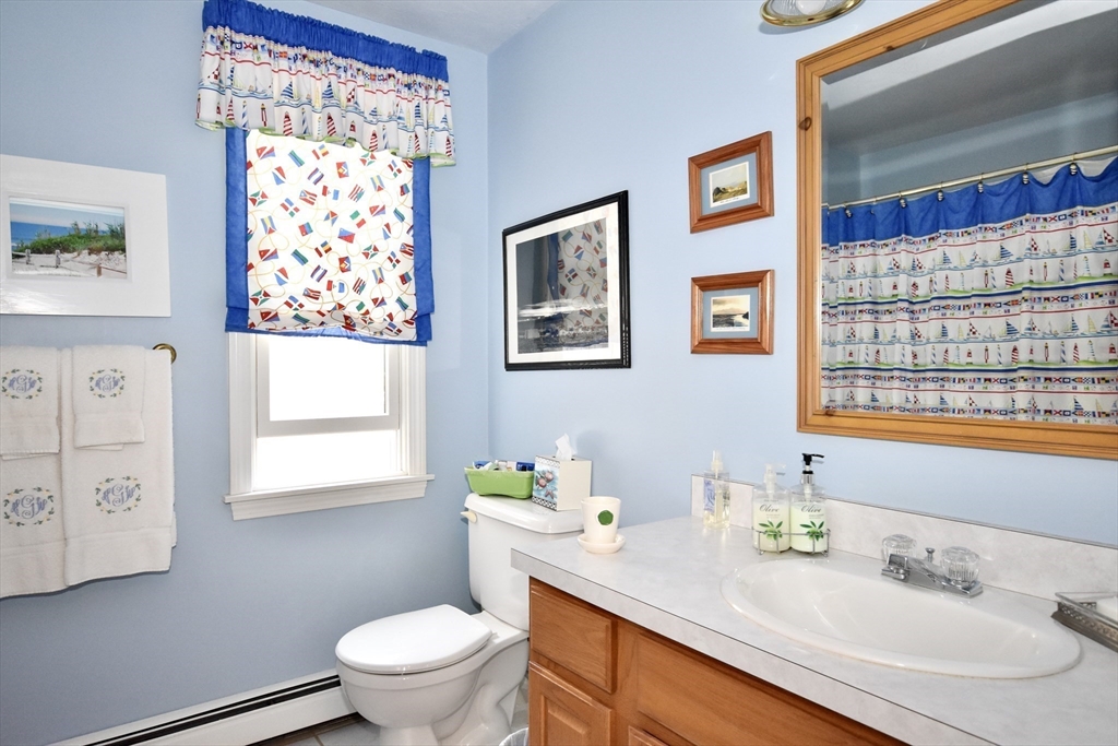 6 Oakbluff Road Bourne, MA 02562 - Photo 33 of 36 a bathroom with a granite countertop sink mirror and a toilet