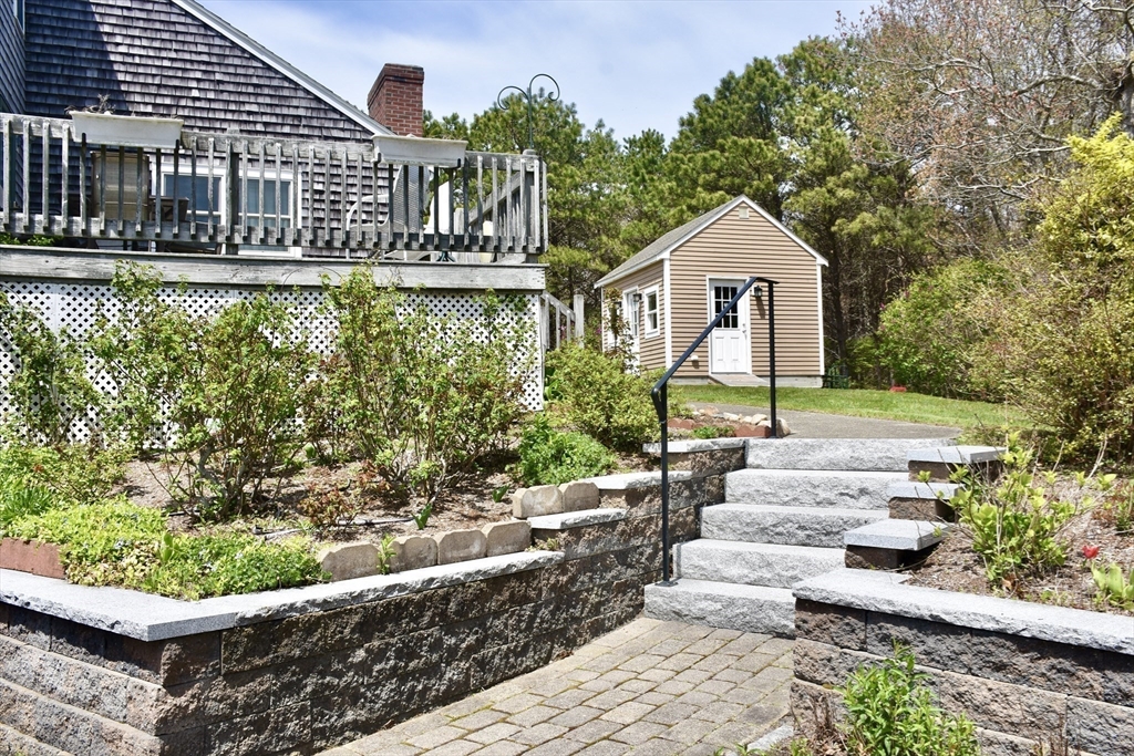6 Oakbluff Road Bourne, MA 02562 - Photo 7 of 36 a front view of a house with a yard and potted plants