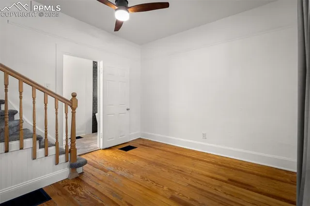 a view of a room with wooden floor and white walls