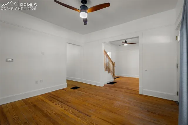 an empty room with wooden floor