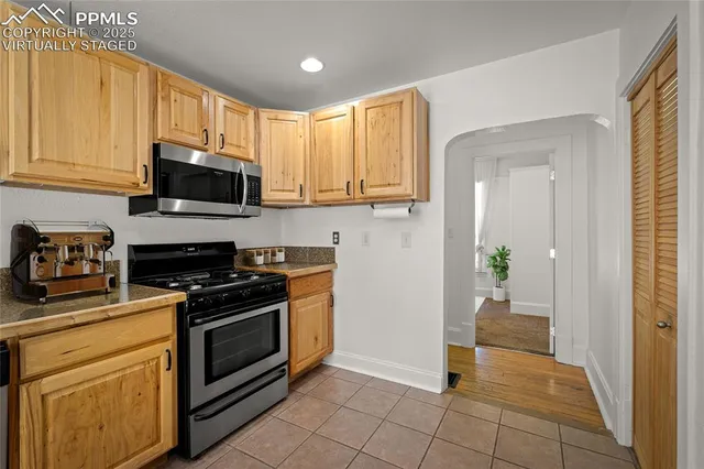 a kitchen with a stove a sink and a microwave
