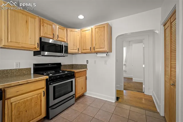 a kitchen with a stove a sink and a microwave