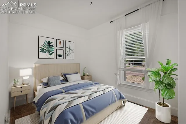 a bedroom with a bed and a potted plant