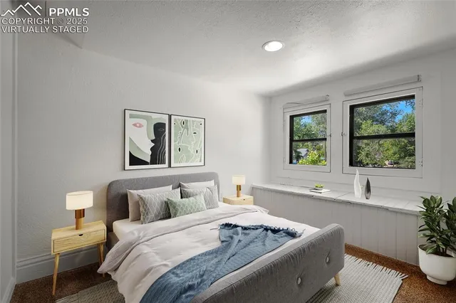 a bedroom with bed and a window