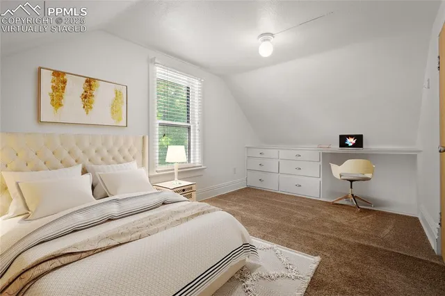 a bedroom with a bed a table and chair