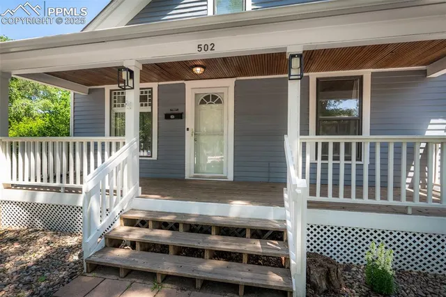 a view of a house with a small deck