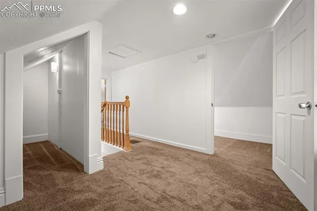 a view of hallway with couch and a potted plant