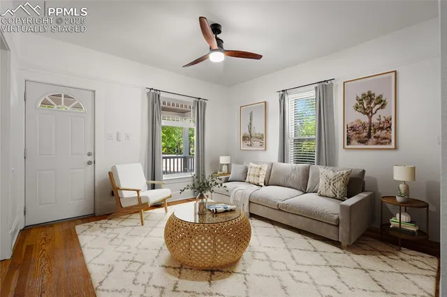a living room with furniture a rug and a window