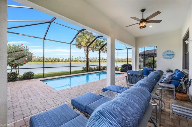 a living room with furniture pool table and a large window