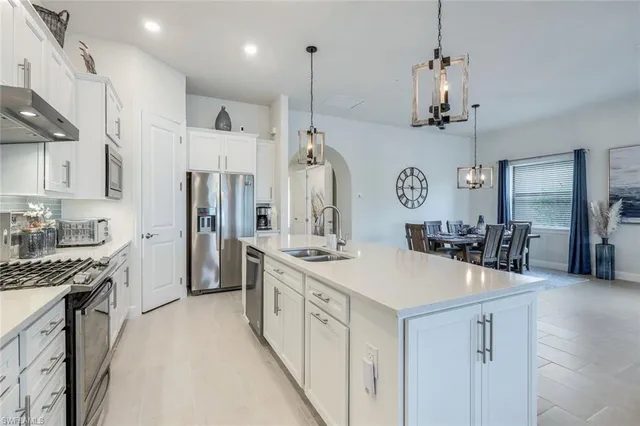 a kitchen with a sink stove and refrigerator