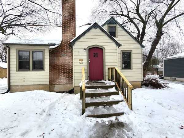 a view of a house with a snow in the yard